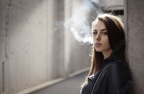 Portrait of a beautiful woman smoking outdoor photo