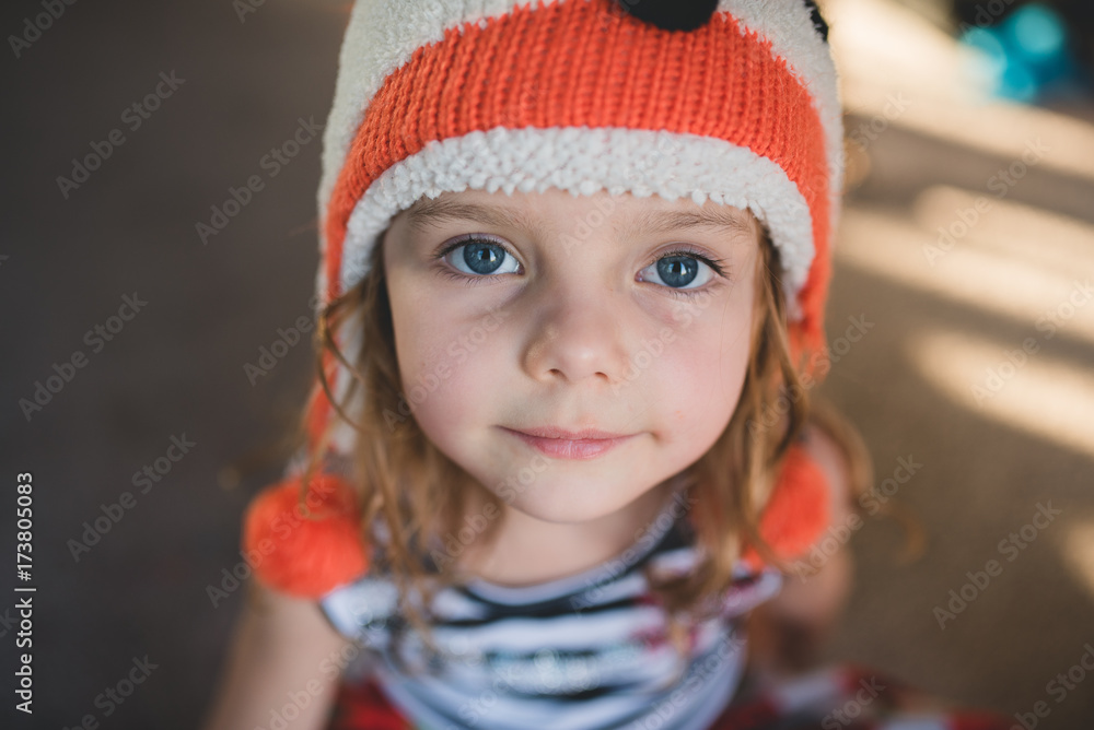 Little girl looking at camera with fox hat on Little girl looking at camera with fox hat on