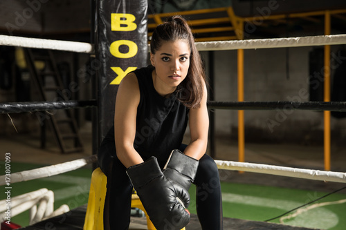 Female boxer sitting in a corner