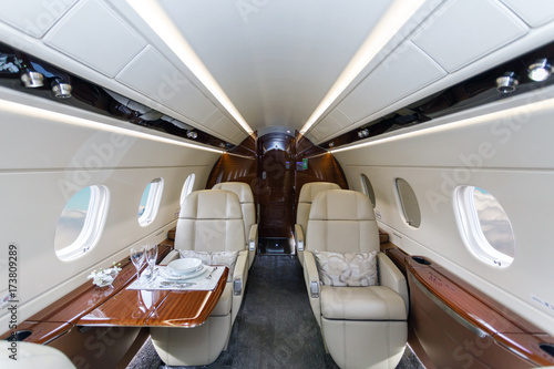 Luxury interior aircraft business aviation and clouds through the porthole