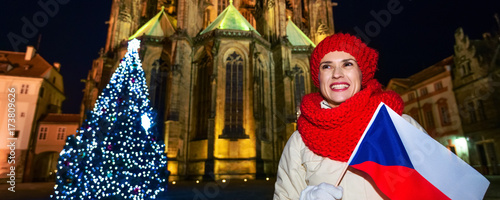 Photography young woman at Christmas tree in Prague with Czech flag