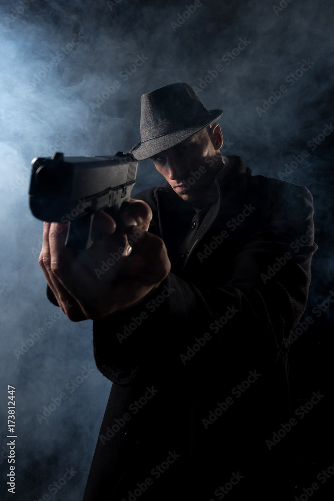 detective or criminal with gun on foggy night background detective or criminal with gun on foggy night background