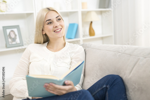 The woman reading a book on the sofa