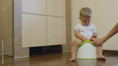Pretty little boy pisses in his potty