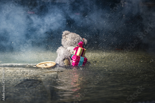 Toys in the rain in a puddle of water