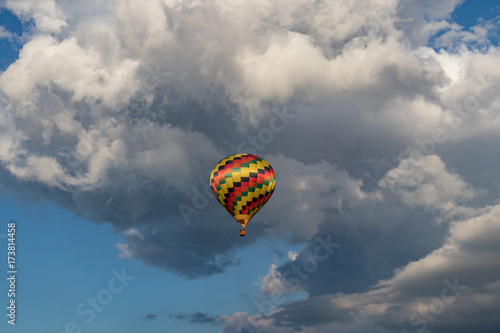 Colorful hot air balloon with puffy clouds in background