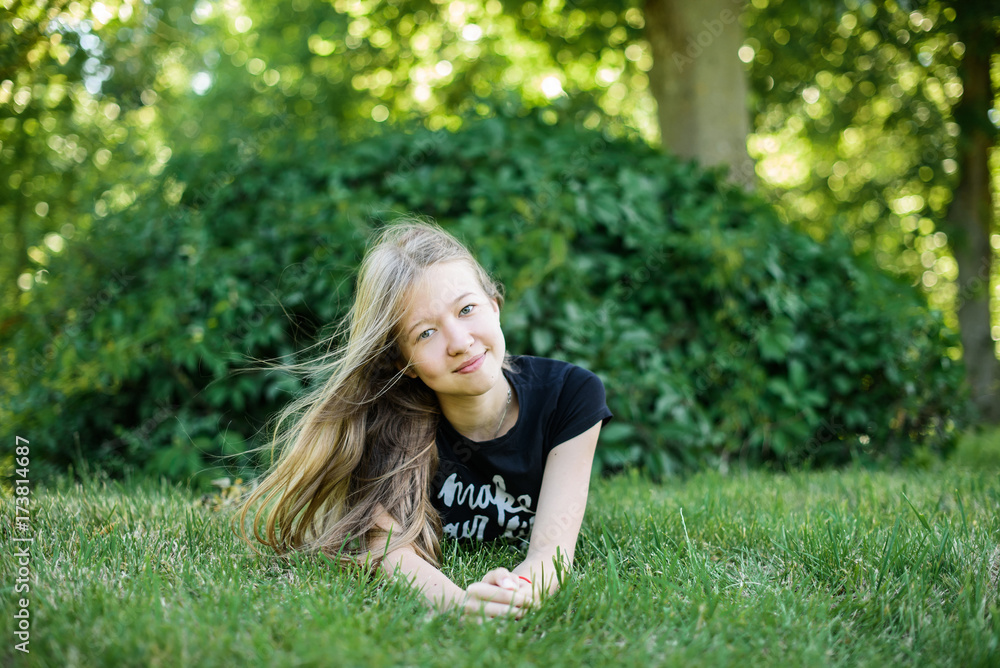 happy smiling girl lies on the grass in the park outdoor happy smiling girl lies on the grass in the park outdoor