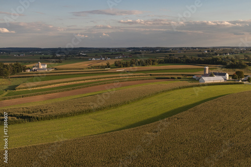 Aerial view of farmland with cloudy sky at sunset