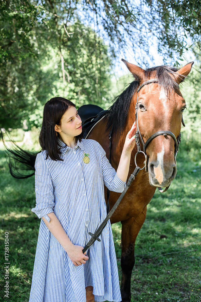 Beautiful girl gently hugs her friend - brown horse Beautiful girl gently hugs her friend - brown horse