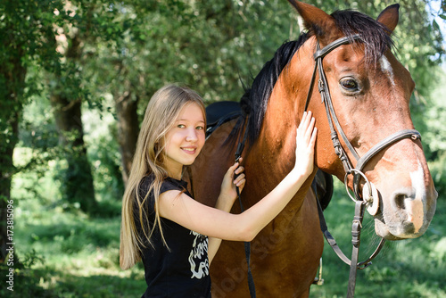Beautiful girl gently hugs her friend - brown horse © Nestyda