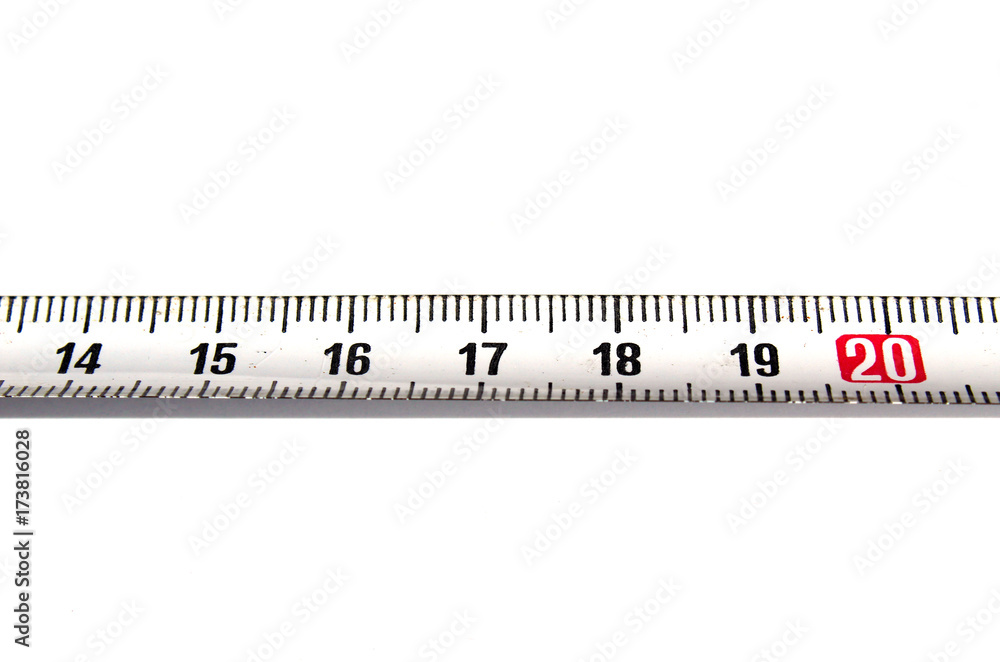 Detail of a metal ruler on white background pointing out number 20 Detail of a metal ruler on white background pointing out number 20
