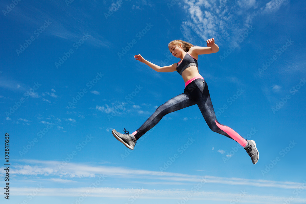 Female athlete remains in air while running Female athlete remains in air while running