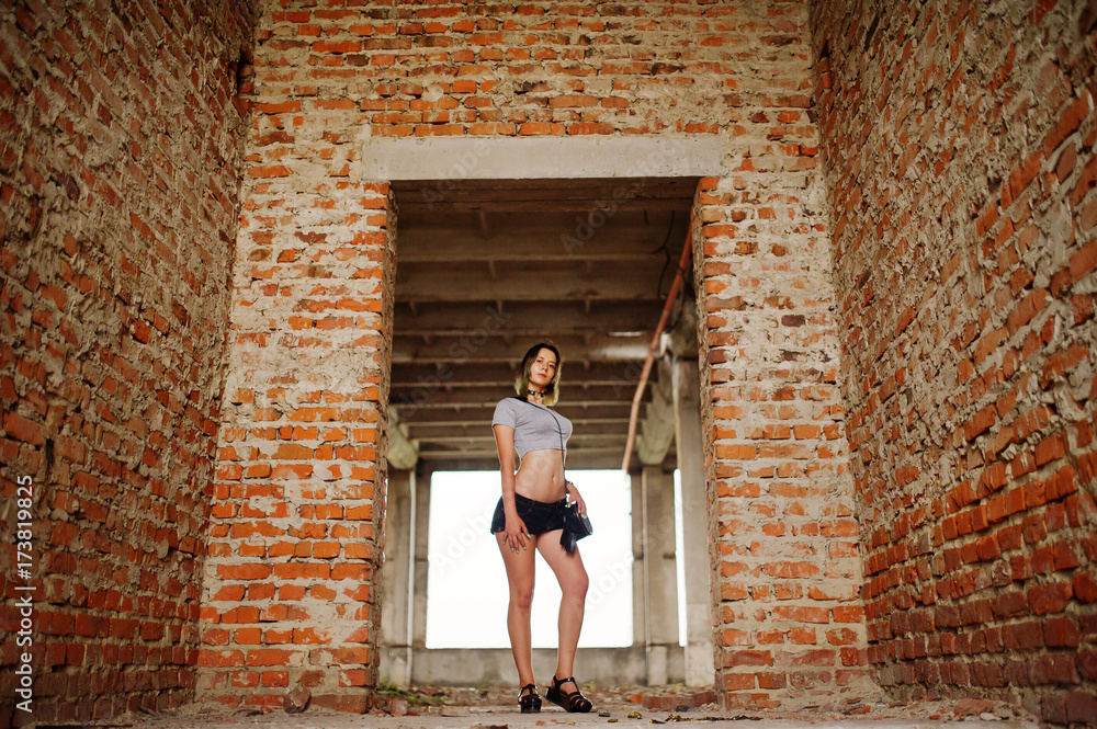 Girl wear on shorts at abadoned factoty with brick walls. Girl wear on shorts at abadoned factoty with brick walls.