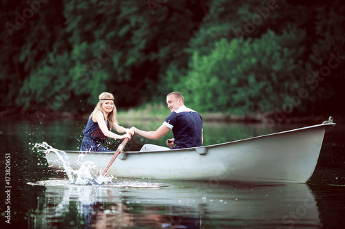 girl and guy rowing on lake © luckyphoto
