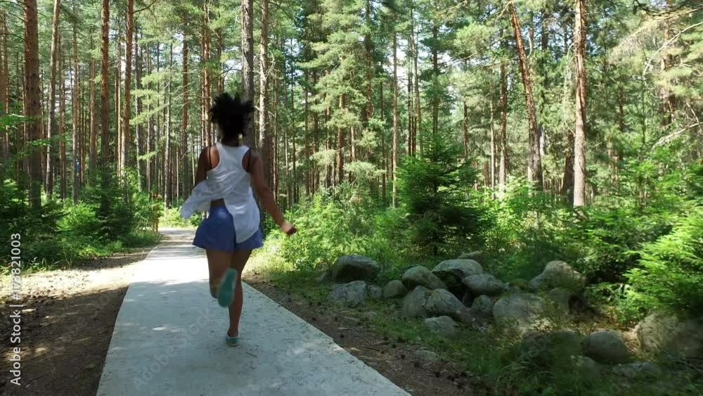 Young fashion model woman with curly hair training in green Young fashion model woman with curly hair training in green