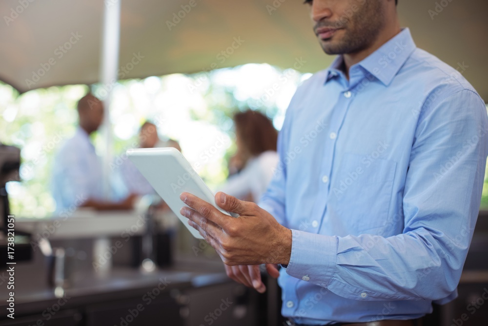 Waiter using digital tablet at outdoor café Waiter using digital tablet at outdoor café