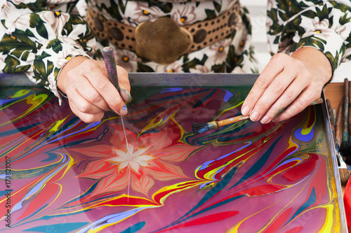 Performing ebru technique.