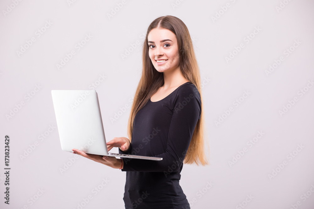 Brunette Woman with laptop and thumb up on white background Brunette Woman with laptop and thumb up on white background