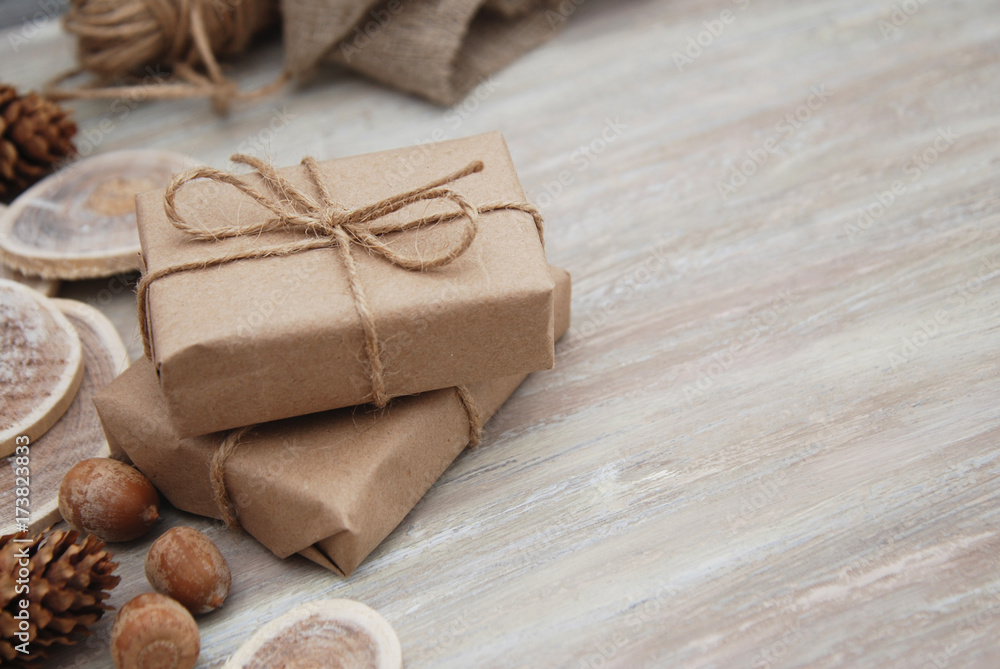 Top view on Christmas gift wrapped in craft and decorateed with various natural things. DIY present idea. Holidays concept. Top view on Christmas gift wrapped in craft and decorateed with various natural things. DIY present idea. Holidays concept.