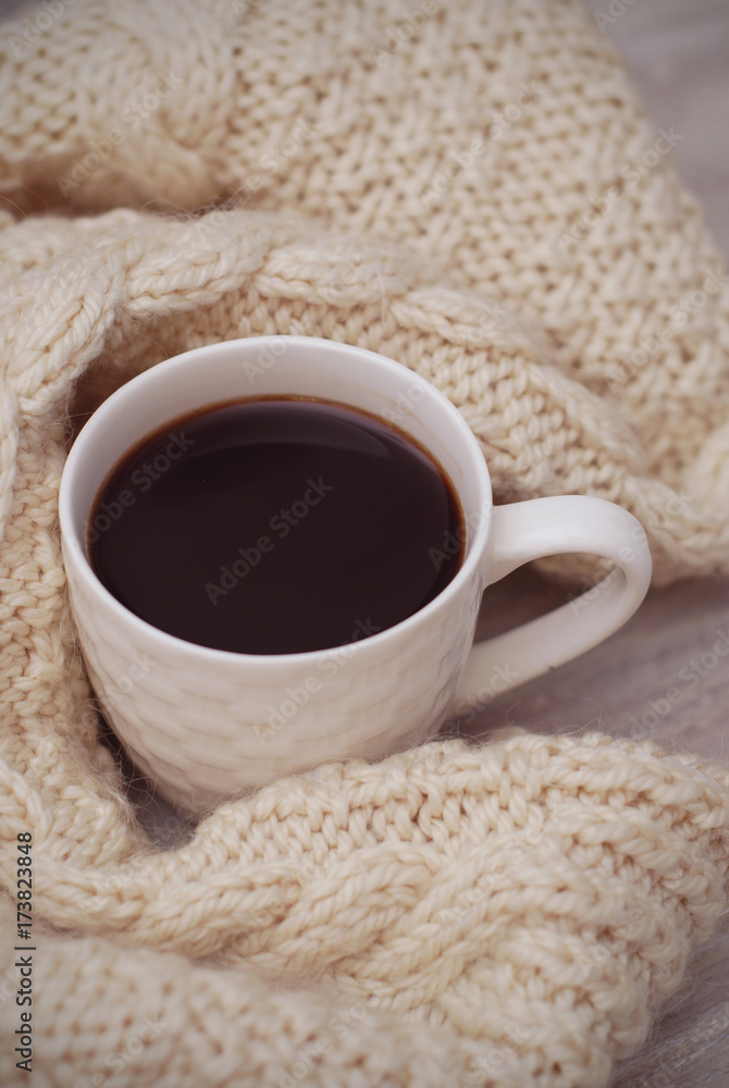 coffee cup with white warm sweater. winter composition. coffee cup with white warm sweater. winter composition.