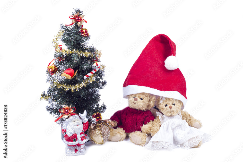 Plush bear cubs near an artificial Christmas tree with Santa Claus Plush bear cubs near an artificial Christmas tree with Santa Claus
