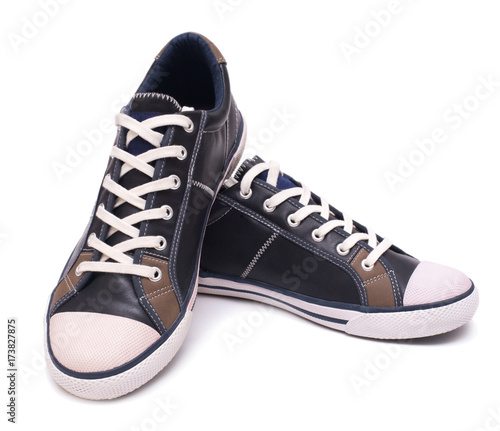 Pair of fashion leather sneakers isolated on white background with clipping path.