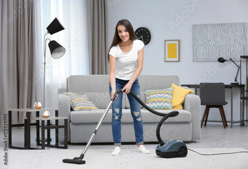 Woman cleaning carpet with ...