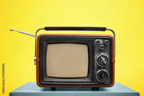 Old vintage TV on color background