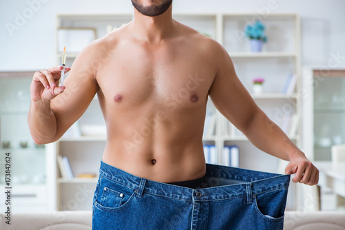 Fotografie Man in oversized pants in weight loss concept