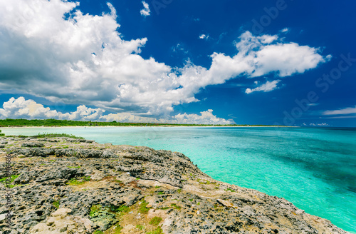 gorgeous, amazing fabulous view from a cliff on tranquil turquoise ocean and beach against blue sky magic background at Cayo Coco Cuban island on sunny beautiful day