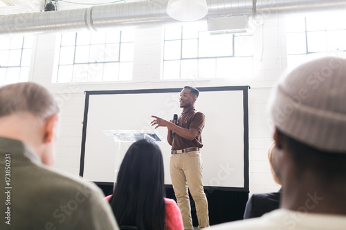 Young man talking on stage