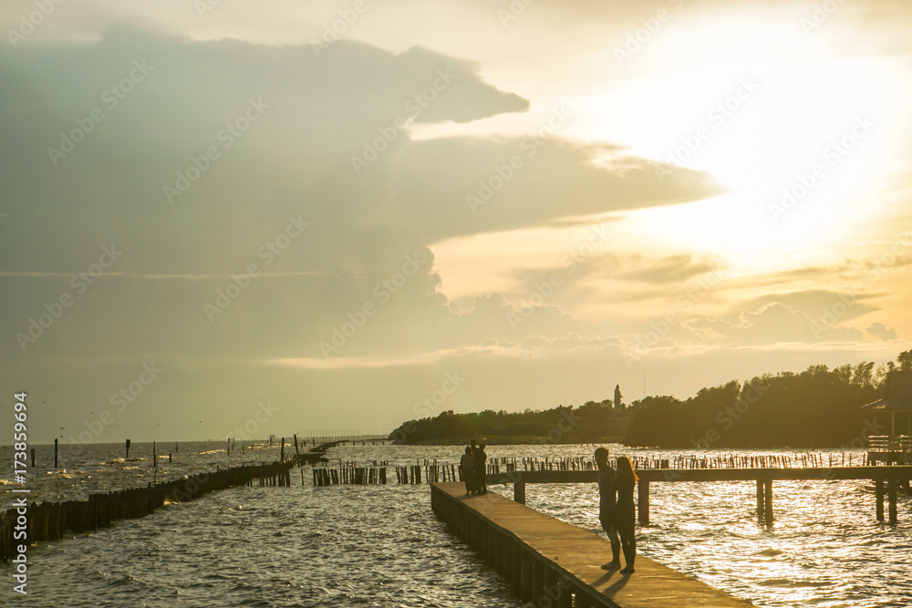 romantic concept - silhouette couple at riverside in sunset
