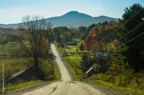 long dirt road going toward a mountain