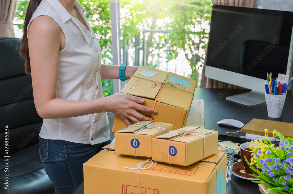 Closeup hand Young asian teenager owner business woman tying a rope prepaing package the product with office equipment online shopping, entrepreneur and alpha generation life style concept Closeup hand Young asian teenager owner business woman tying a rope prepaing package the product with office equipment online shopping, entrepreneur and alpha generation life style concept