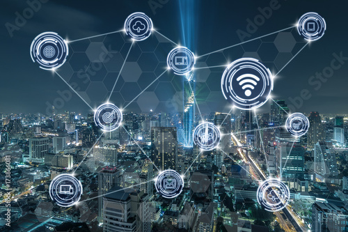 Wireless communication connecting of smart city Internet of Things Technology over the Top view of Bangkok Cityscape at night, Mahanakhon, technology business IOT concept #173866081