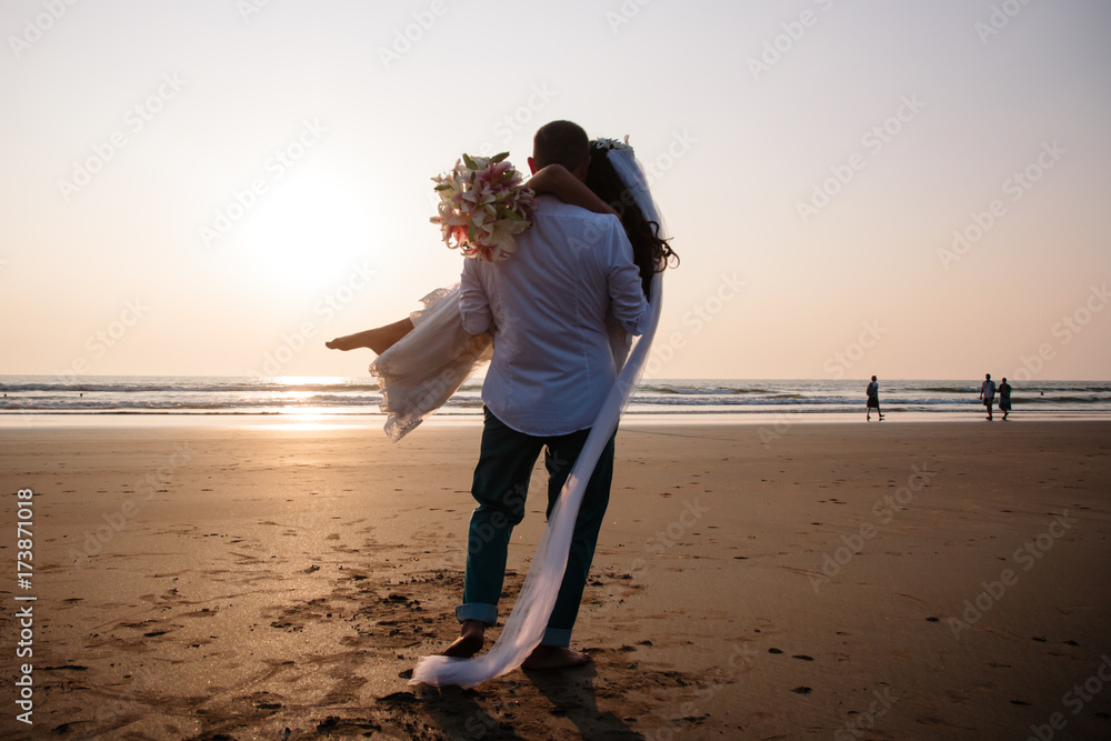 Lovers were married in India. Walk on the beach