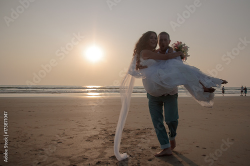 Lovers were married in India. Walk on the beach photo