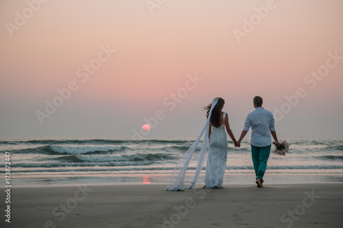 Lovers were married in India. Walk on the beach