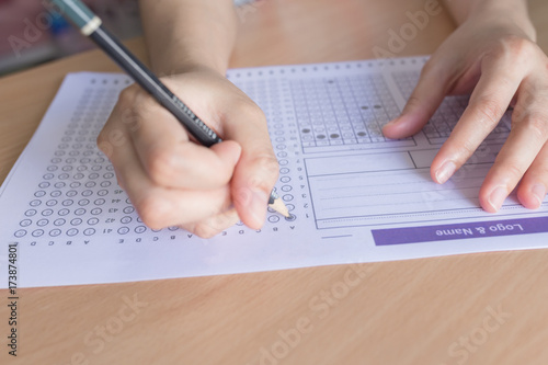 Selective focus Student filling out answers to a test with a pencil.