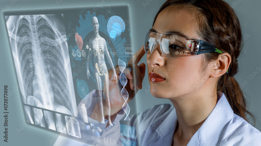 Young female doctor looking at hologram screen. Electronic medical record. Smart glasses. Medical technology concept. - obrazy, fototapety, plakaty 