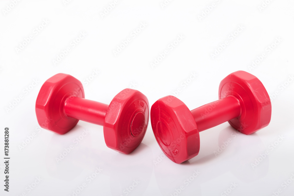 Red dumbells. Isolated on a White Background. Red dumbells. Isolated on a White Background.