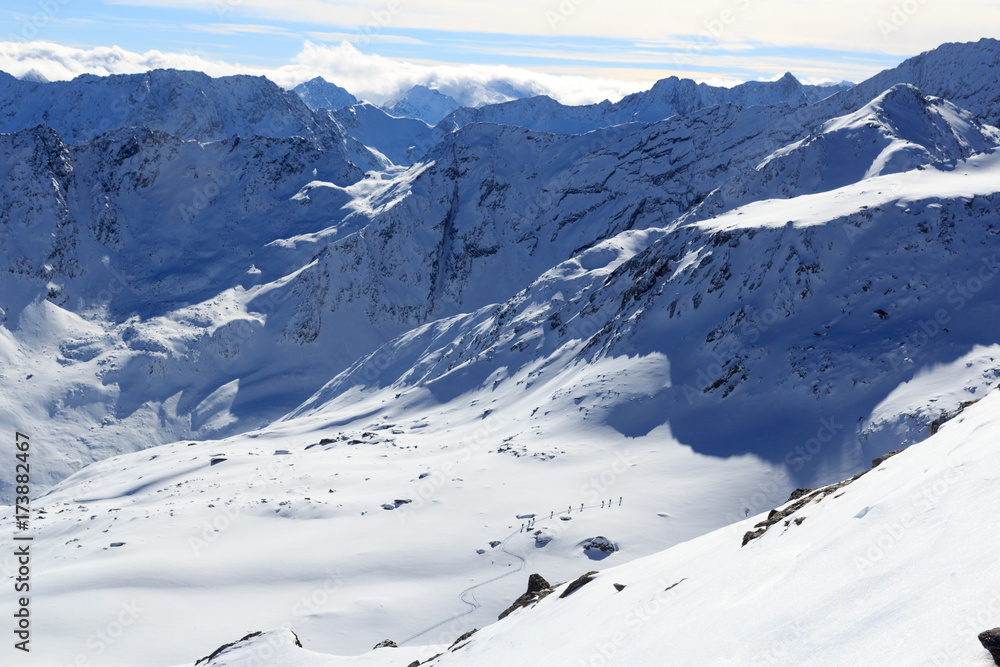 Group of people ski mountaineering and mountain snow panorama in Stubai Alps, Austria