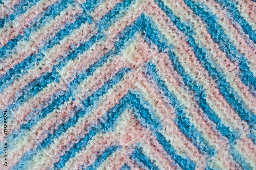 The knitted plaid of a multi-colored wool. Handmade. Heat of the home. Plaid and a cup of coffee or cocoa The knitted plaid of a multi-colored wool. Handmade. Heat of the home. Plaid and a cup of coffee or cocoa