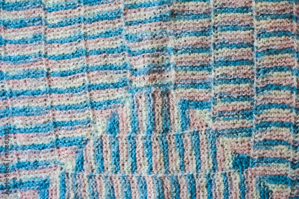 The knitted plaid of a multi-colored wool. Handmade. Heat of the home. Plaid and a cup of coffee or cocoa The knitted plaid of a multi-colored wool. Handmade. Heat of the home. Plaid and a cup of coffee or cocoa