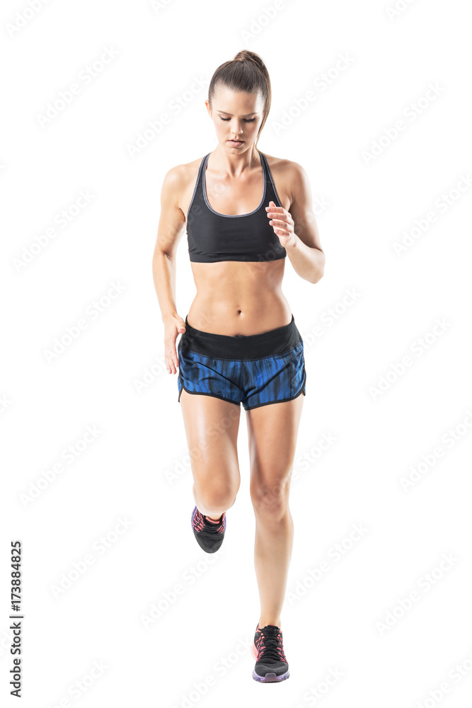 Front view of athletic fit woman sprinting and look down without hair motion. Full body length portrait isolated on white studio background. Front view of athletic fit woman sprinting and look down without hair motion. Full body length portrait isolated on white studio background.