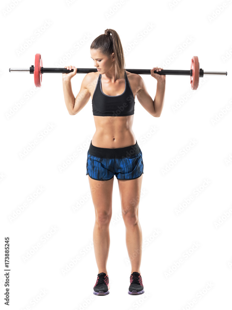 End extended up position of woman athlete doing shoulder press squat exercise. Full body length portrait isolated on white studio background. End extended up position of woman athlete doing shoulder press squat exercise. Full body length portrait isolated on white studio background.