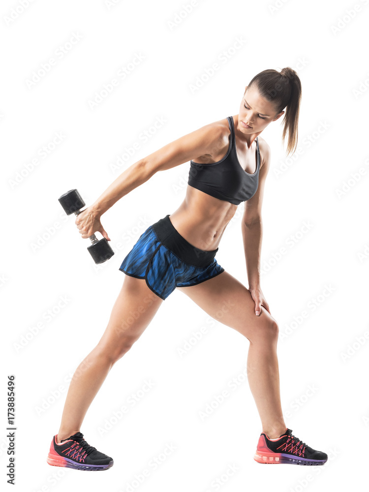 Profile of bend fit athletic female doing triceps exercise in extended position. Full body length portrait isolated on white studio background. Profile of bend fit athletic female doing triceps exercise in extended position. Full body length portrait isolated on white studio background.