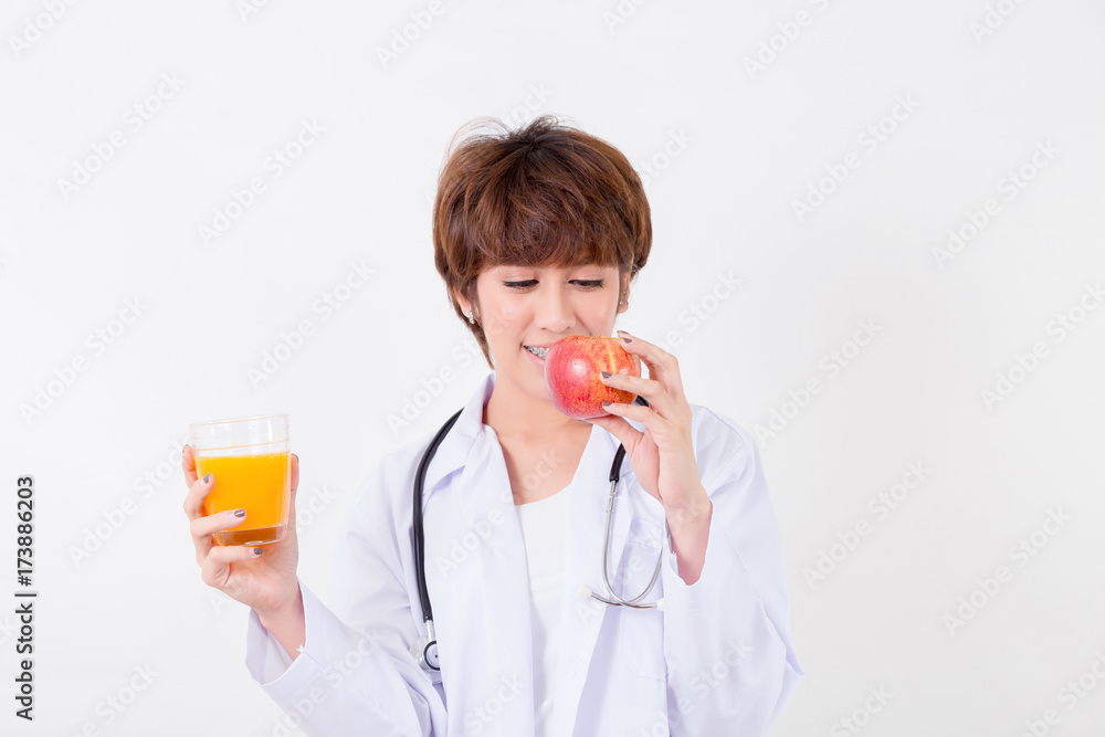 Happy woman doctor holding the red heart and orange juice. Isolated on white background. Studio lighting. Concept for healthy and medical Happy woman doctor holding the red heart and orange juice. Isolated on white background. Studio lighting. Concept for healthy and medical
