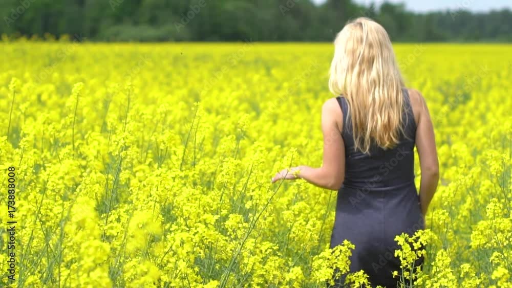 young blonde woman posing in beautiful rapeseed field young blonde woman posing in beautiful rapeseed field