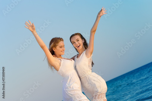 Two women in a white dress on beach